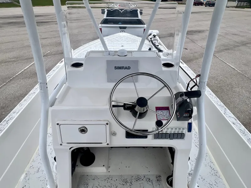 Slide: The Image of 2015 Shallow Sport 24 Modified V boat console with steering wheel and Simrad display. - 10