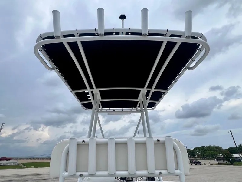 Slide: The Image of 2015 Shallow Sport 24 Modified V boat with T-top under cloudy sky. - 11