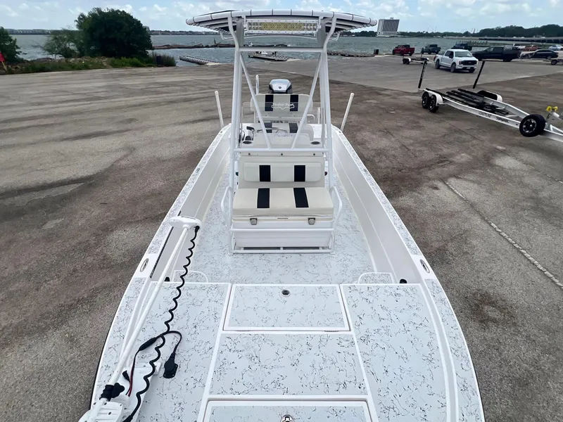 Slide: The Image of 2015 Shallow Sport 24 Modified V boat at a dock with scenic water view. - 15