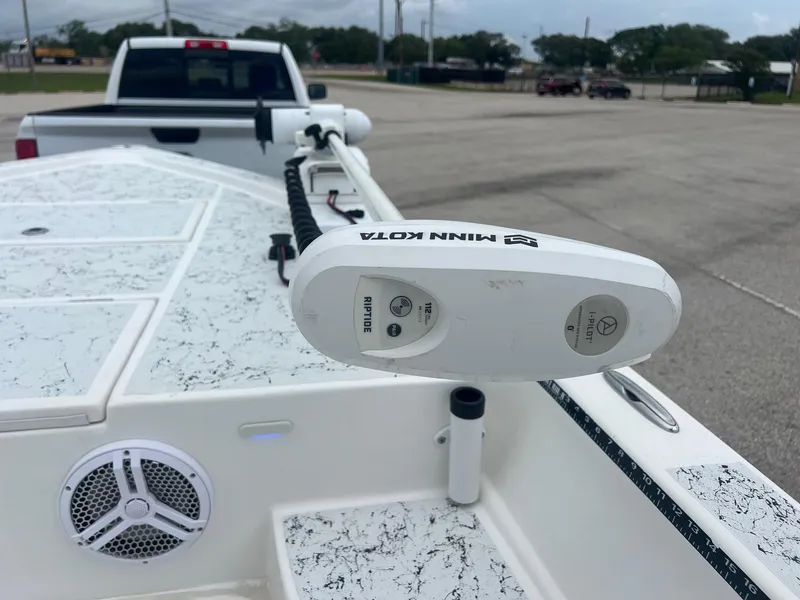 Slide: The Image of 2015 Shallow Sport 24 Modified V boat with Minn Kota trolling motor in parking lot. - 17