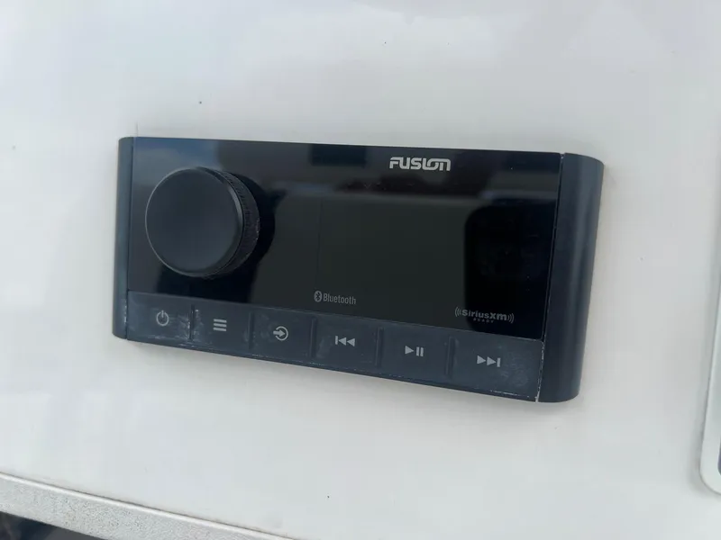 Slide: The Image of Fusion audio control panel on 2015 Shallow Sport 24 Modified V boat. - 19