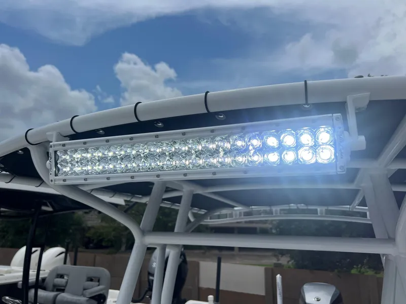 Slide: The Image of 2015 Shallow Sport 24 Modified V boat with LED light bar under cloudy sky. - 21