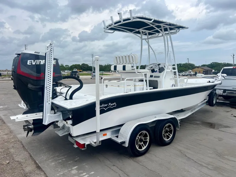 Slide: The Image of 2015 Shallow Sport 24 Modified V boat on trailer with Evinrude outboard motor. - 4