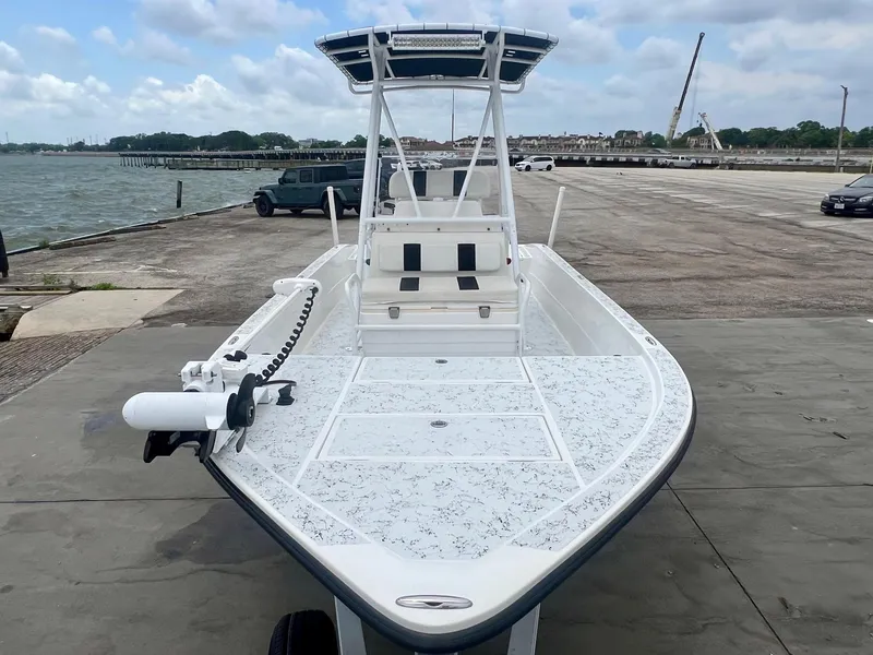 Slide: The Image of 2015 Shallow Sport 24 Modified V boat docked by the waterfront. - 6