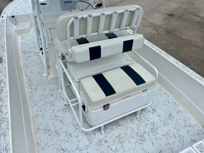 Slide: The Image of 2015 Shallow Sport 24 Modified V boat with cushioned seating and rod holders. - 8