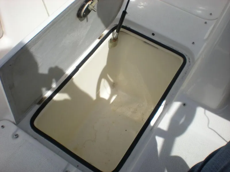 Slide: The Image of Storage compartment of a 2011 Yamaha AR210 boat, open and empty. - 1