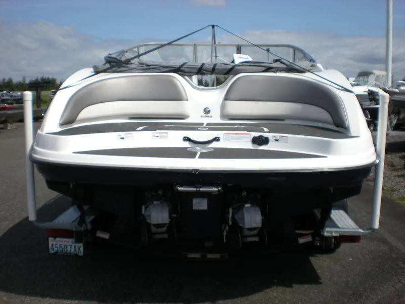 Slide: The Image of 2011 Yamaha AR210 boat, rear view, on a trailer, showcasing sleek design and dual engines. - 10