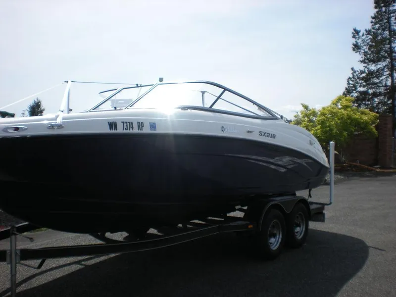 Slide: The Image of 2011 Yamaha AR210 boat on trailer, parked outdoors. - 11