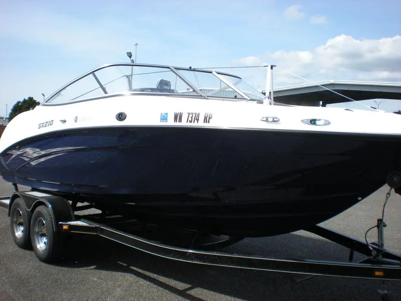 Slide: The Image of 2011 Yamaha AR210 boat on trailer, sleek design, parked outdoors under blue sky. - 12