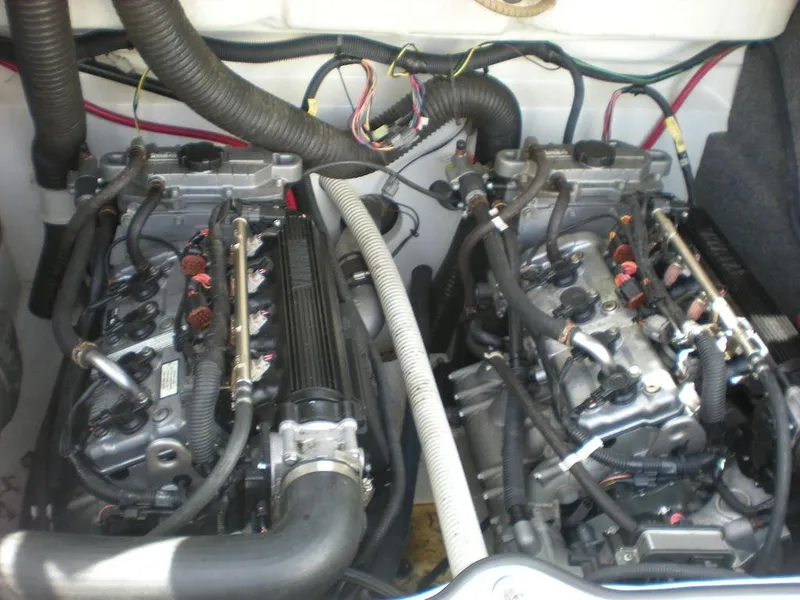Slide: The Image of 2011 Yamaha AR210 boat engine compartment with dual engines and visible wiring. - 2