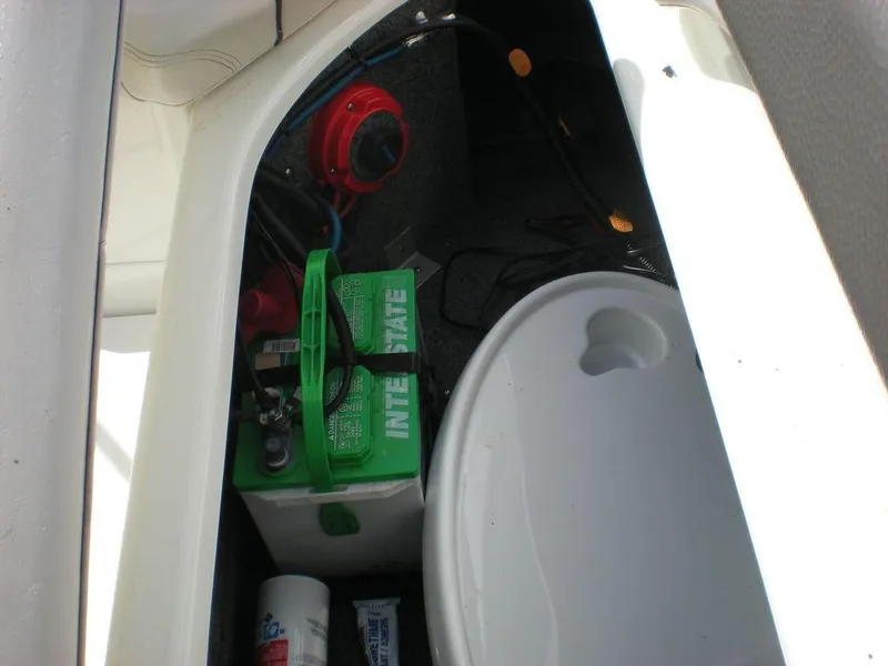 Slide: The Image of 2011 Yamaha AR210 boat storage compartment with battery and accessories. - 3
