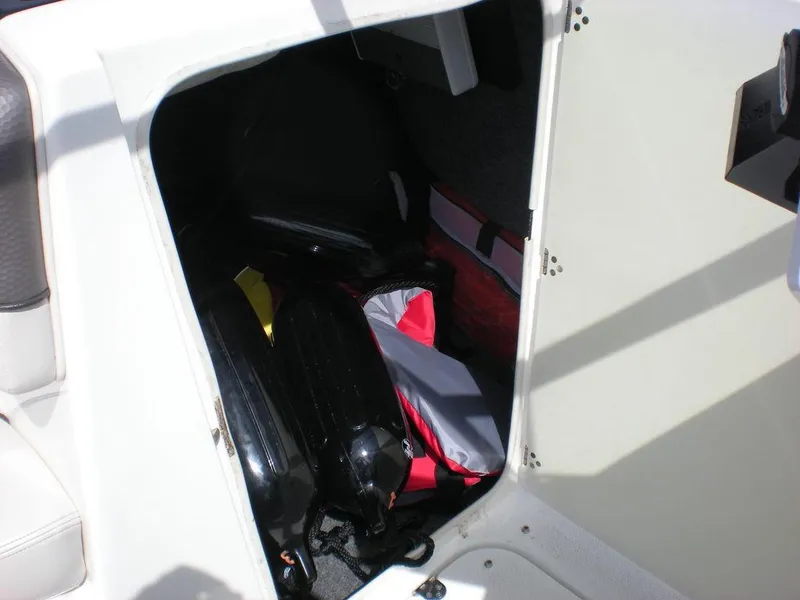 Slide: The Image of Storage compartment in a 2011 Yamaha AR210 boat, containing various boating gear. - 5