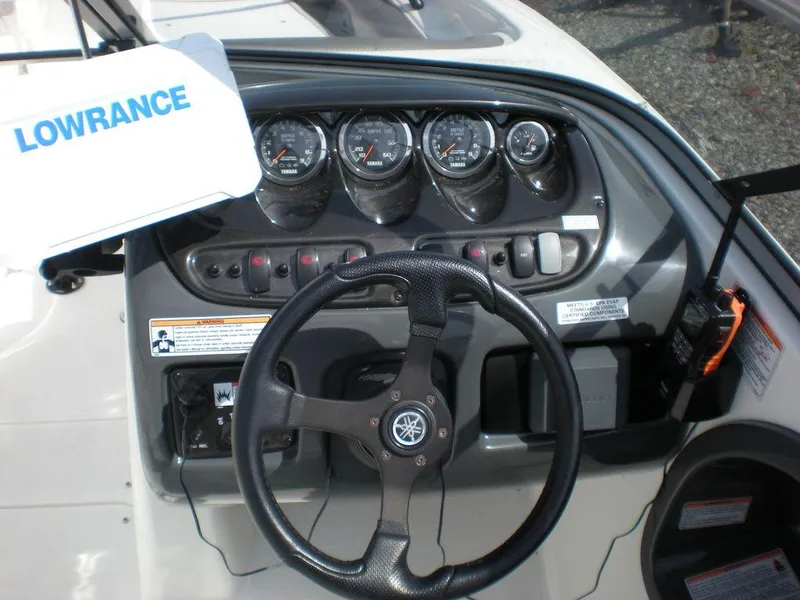 Slide: The Image of 2011 Yamaha AR210 boat dashboard with steering wheel and gauges. - 7