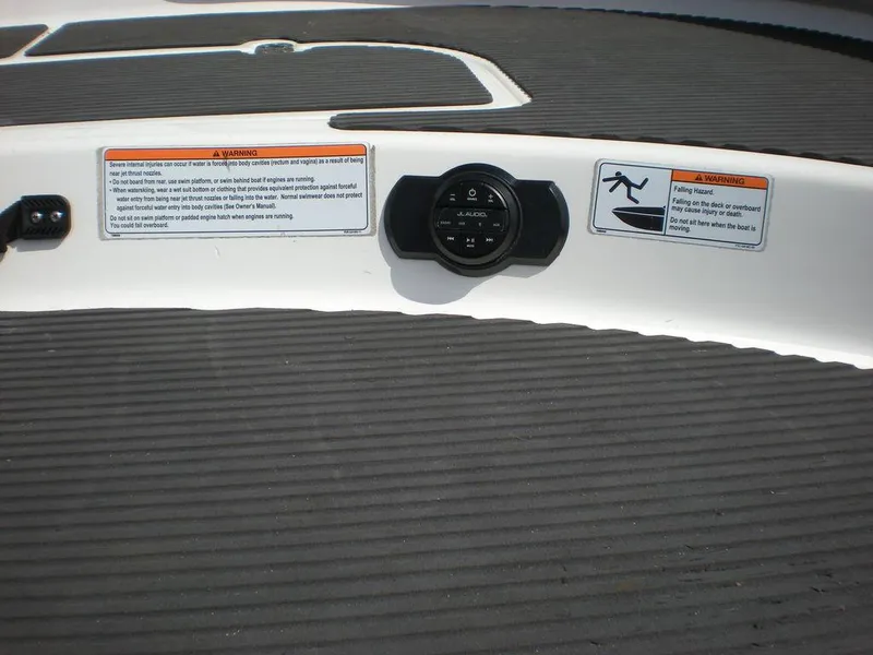 Slide: The Image of 2011 Yamaha AR210 boat deck with safety warnings and control panel. - 9