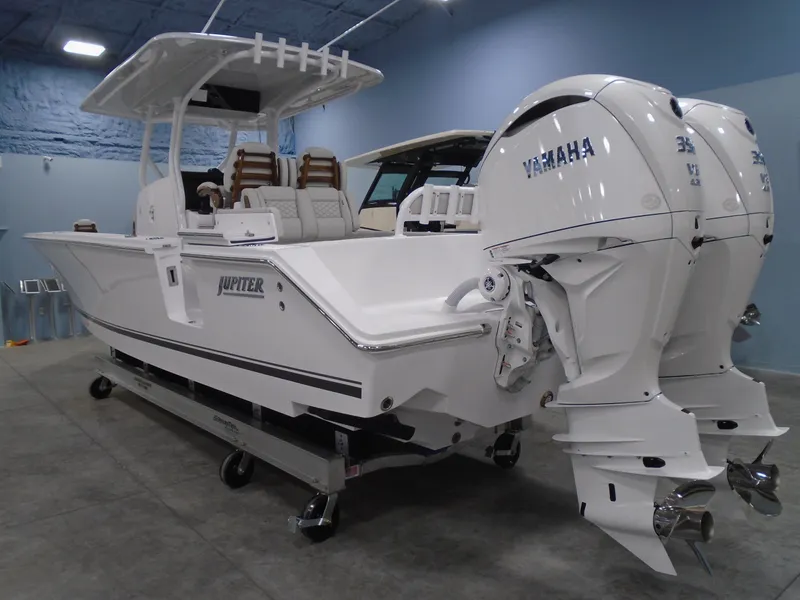 Slide: The Image of 2025 Jupiter 32 boat with twin Yamaha engines in a showroom setting. - 11