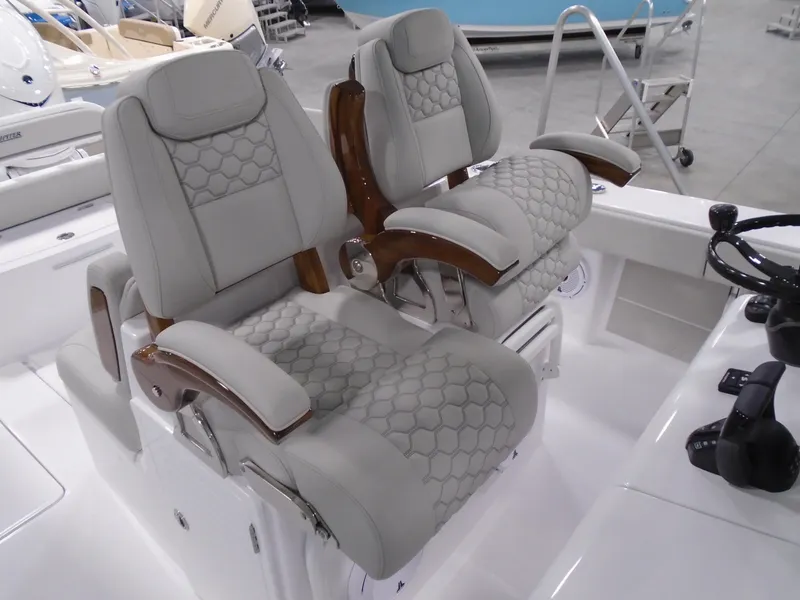 Slide: The Image of Luxurious seating on a 2025 Jupiter 32 boat, featuring elegant upholstery and wooden armrests. - 18