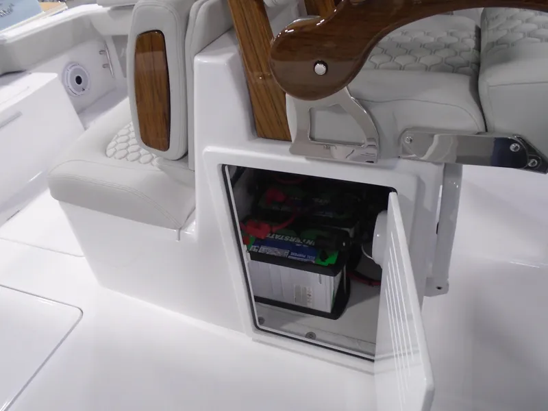 Slide: The Image of Battery compartment in a 2025 Jupiter 32 boat, featuring sleek white and wood interior design. - 19