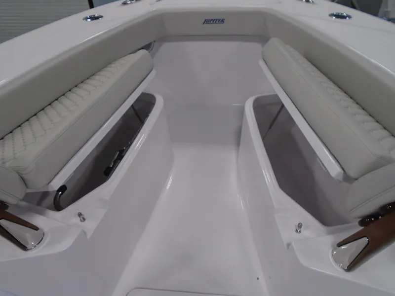Slide: The Image of 2025 Jupiter 32 boat interior with cushioned seating and storage compartments. - 30