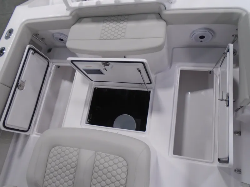 Slide: The Image of 2025 Jupiter 32 boat interior with open storage compartments and cushioned seating. - 32