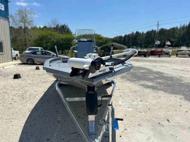 Slide: The Image of 2025 Xpress H210B boat on trailer in outdoor setting, featuring Minn Kota trolling motor. - 5