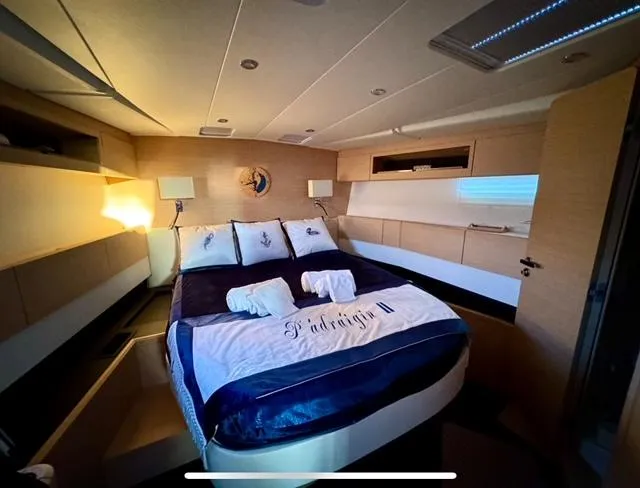 Slide: The Image of Luxurious bedroom interior of 2016 Jeanneau 58 yacht with elegant bedding and ambient lighting. - 19