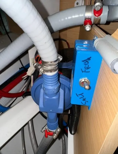 Slide: The Image of Water pump system in a 2016 Jeanneau 58 yacht, featuring labeled pipes and secure fittings. - 21