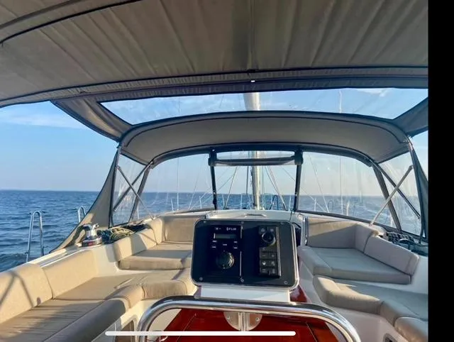 Slide: The Image of 2016 Jeanneau 58 yacht cockpit with canopy, sailing on open sea. - 29