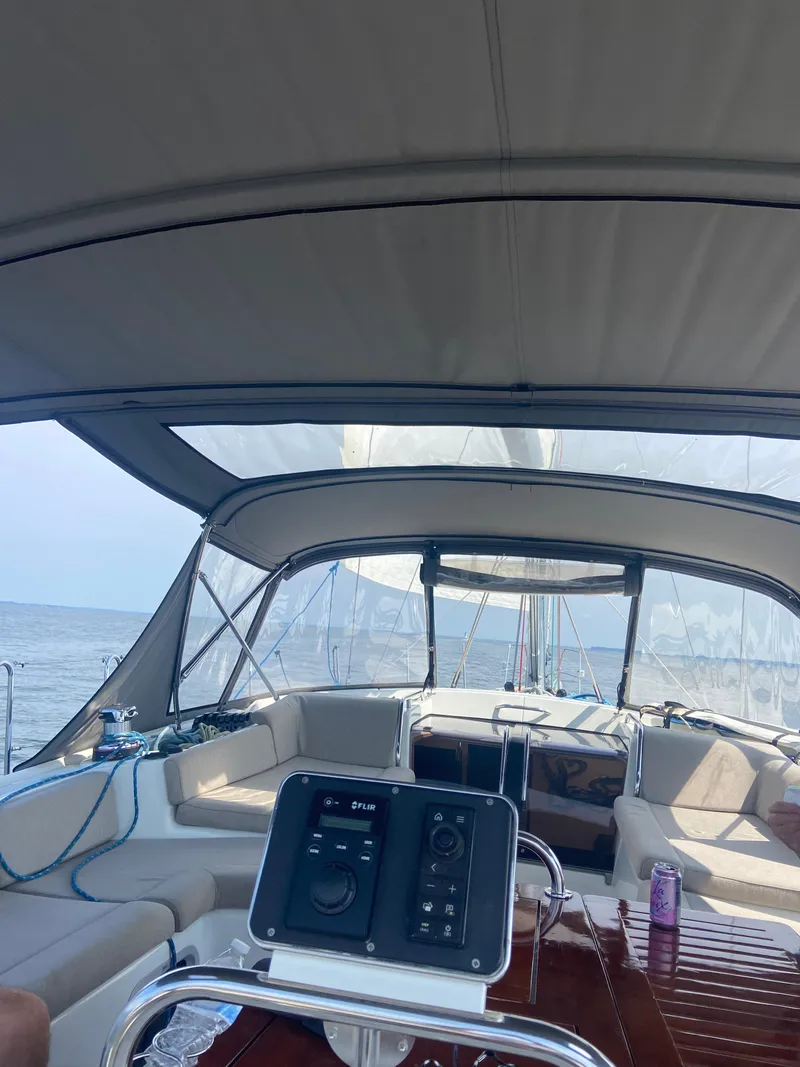 Slide: The Image of 2016 Jeanneau 58 yacht interior with helm, canopy, and ocean view. - 4