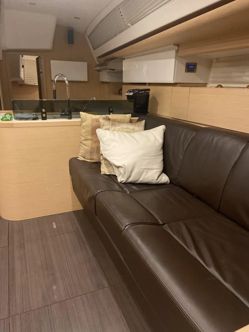 Slide: The Image of Interior of 2016 Jeanneau 58 yacht with leather sofa and modern kitchen area. - 6
