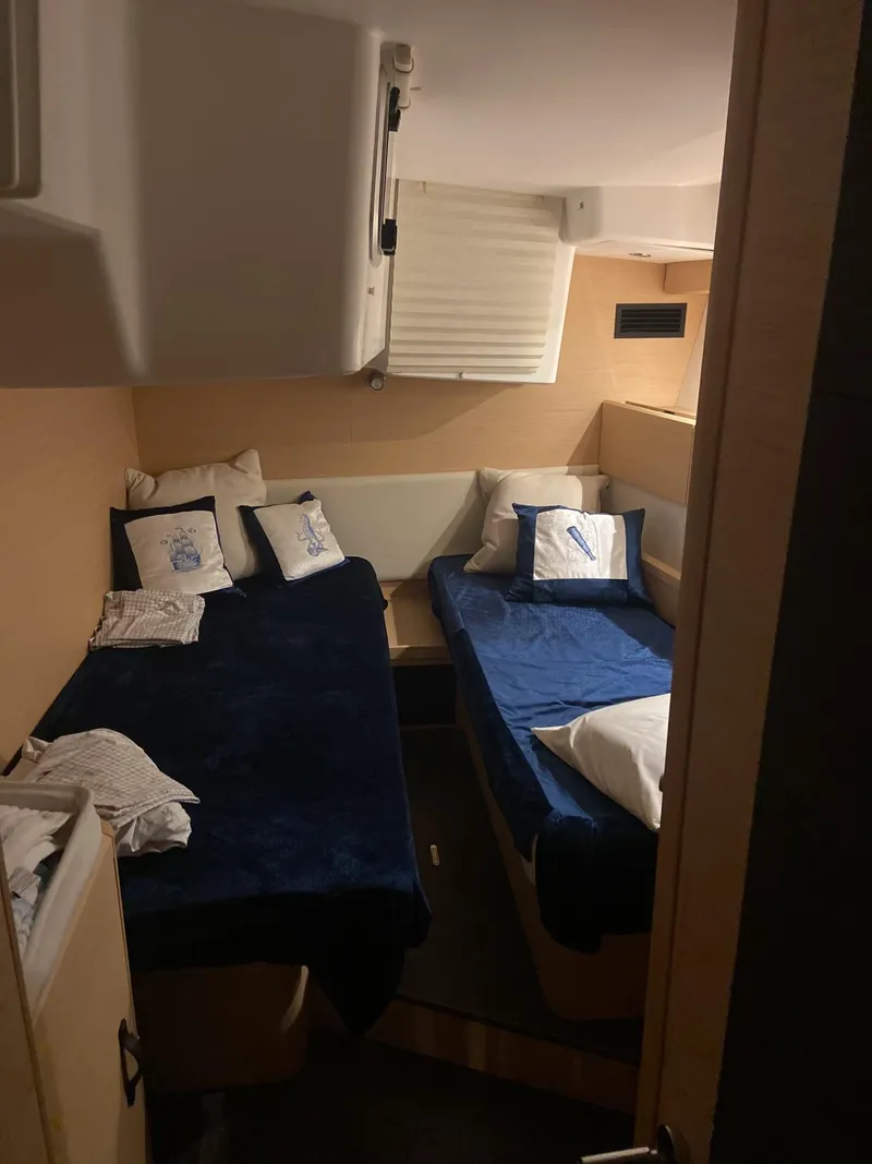 Slide: The Image of Interior cabin of 2016 Jeanneau 58 yacht with twin beds and nautical-themed decor. - 9