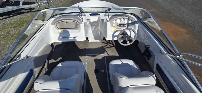 Slide: The Image of 2003 Reinell 185 boat interior with steering wheel and seating. - 2