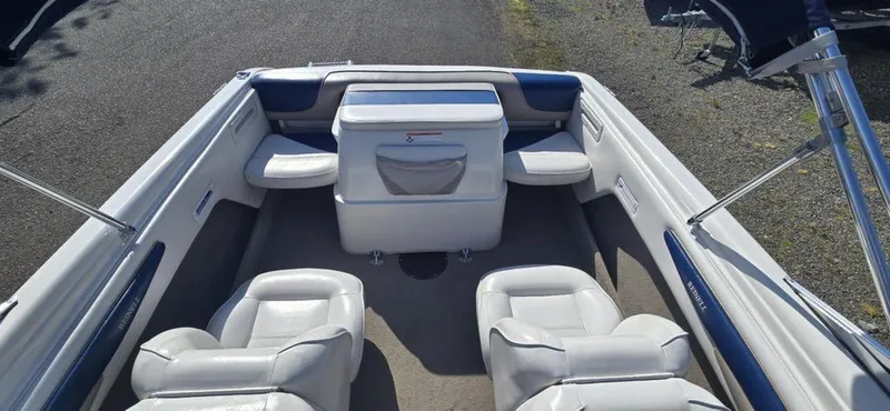 Slide: The Image of 2003 Reinell 185 boat interior with white seating and blue accents. - 3