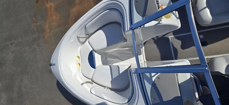 Slide: The Image of 2003 Reinell 185 boat interior with white seating and blue accents, viewed from above. - 7