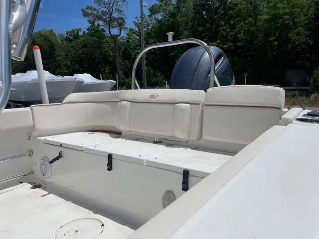 Slide: The Image of 2022 Sea Hunt Ultra 229 boat interior with white seating and outdoor setting. - 7