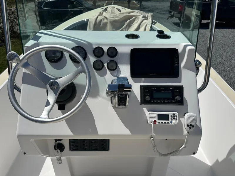 Slide: The Image of Control panel of a 2007 Holby Pilot 20 boat with steering wheel and navigation equipment. - 3