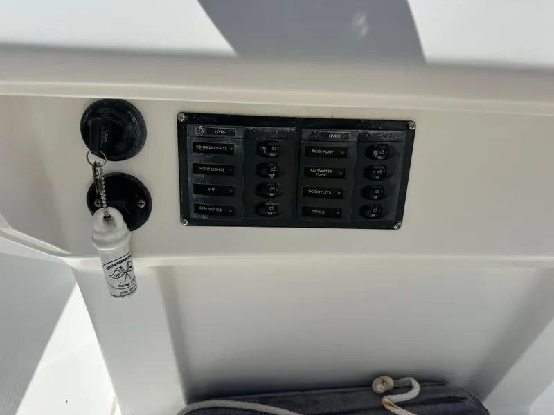 Slide: The Image of Control panel on a 2007 Holby Pilot 20 boat with switches and keychain. - 4