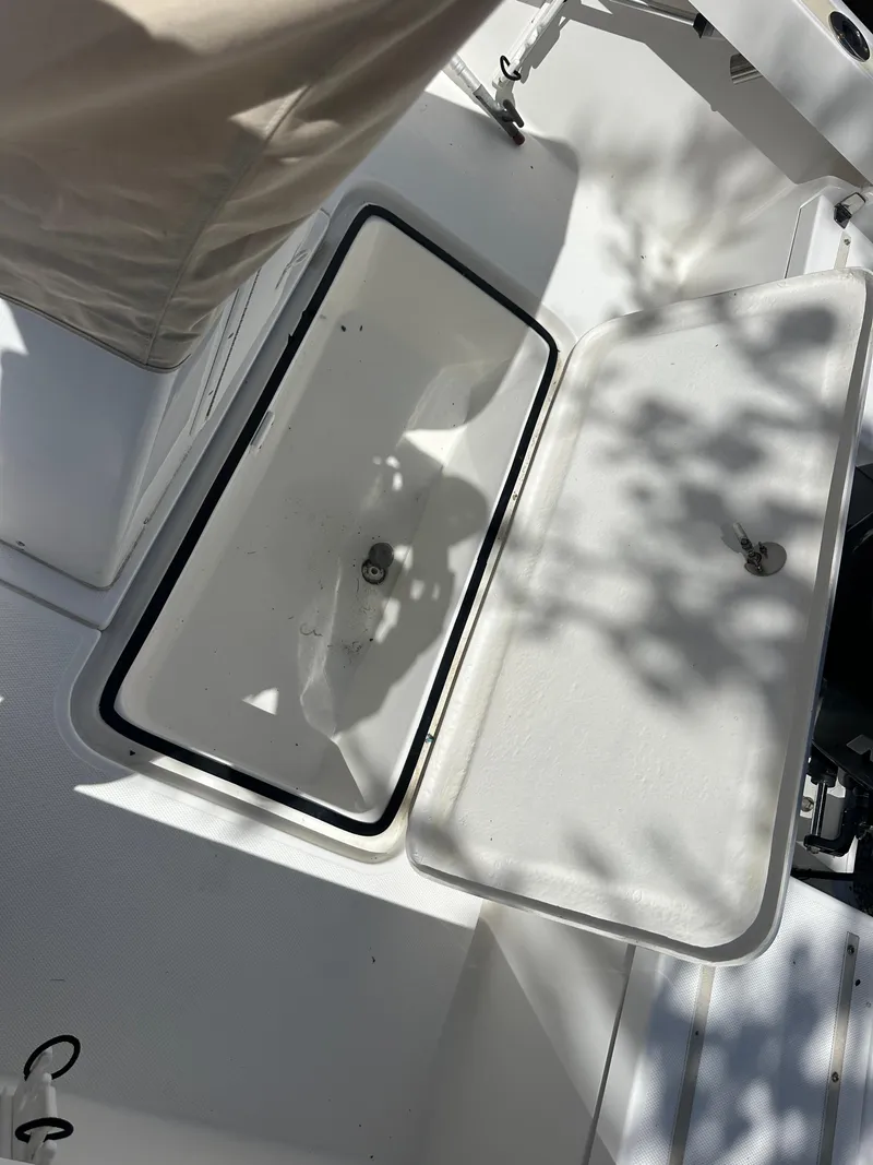 Slide: The Image of Open storage compartment on a 2007 Holby Pilot 20 boat, with sunlight and shadows. - 8