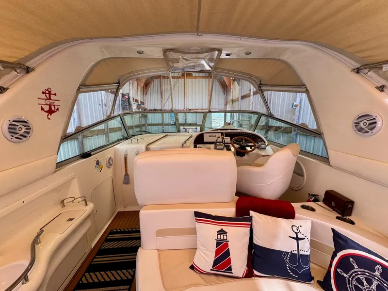 Slide: The Image of Interior of 2000 Sea Ray 310 Sundancer with nautical-themed decor and helm station. - 14