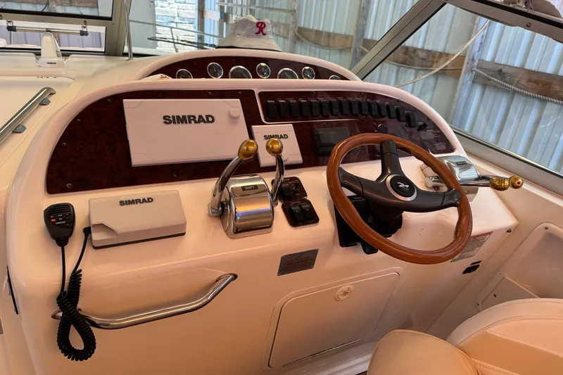 Slide: The Image of Helm of 2000 Sea Ray 310 Sundancer with Simrad electronics and wooden steering wheel. - 17