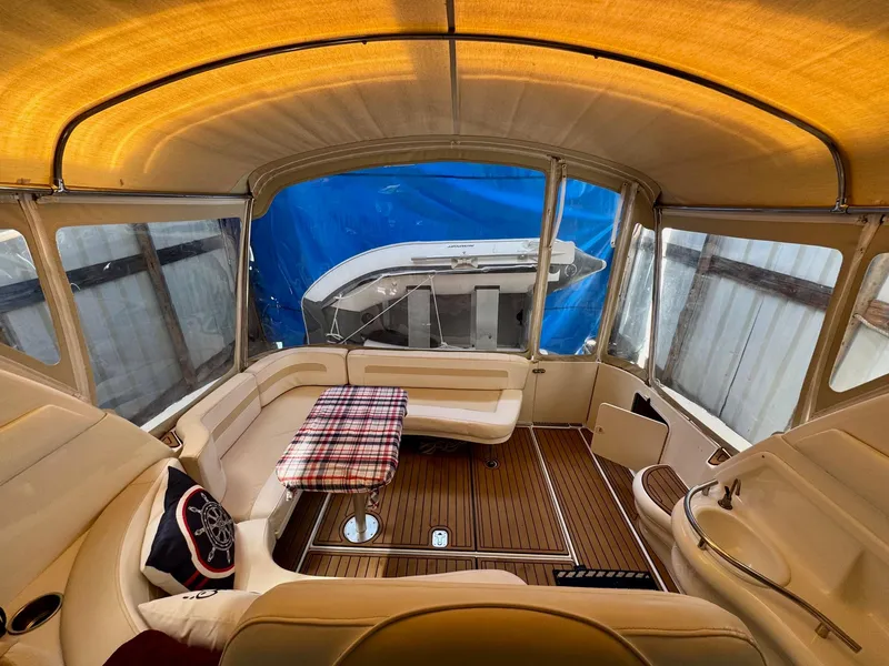 Slide: The Image of Interior of 2000 Sea Ray 310 Sundancer with cozy seating and wooden flooring. - 20