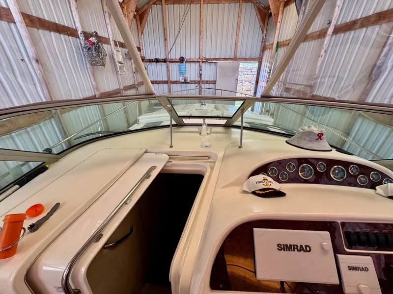 Slide: The Image of Cockpit view of 2000 Sea Ray 310 Sundancer with Simrad equipment in a boathouse. - 21