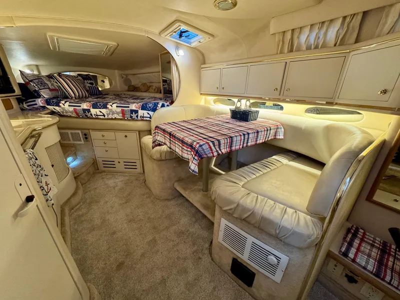 Slide: The Image of Interior of 2000 Sea Ray 310 Sundancer with cozy seating and dining area. - 22