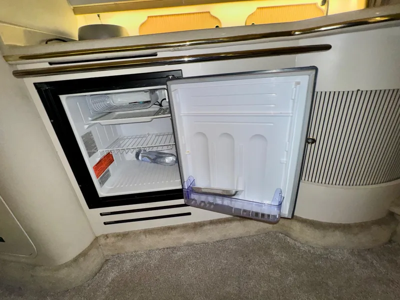 Slide: The Image of Open mini fridge inside 2000 Sea Ray 310 Sundancer boat cabin. - 28