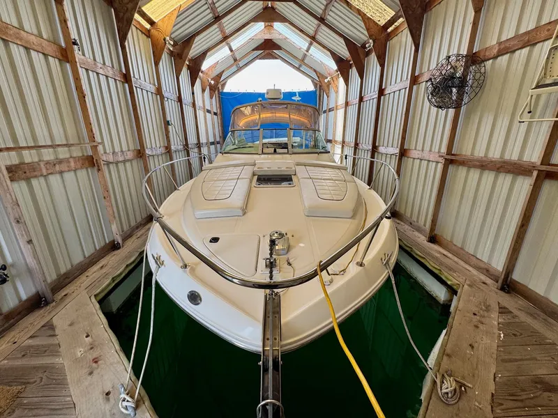 Slide: The Image of 2000 Sea Ray 310 Sundancer docked in a covered boathouse. - 3
