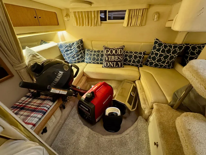 Slide: The Image of Interior of 2000 Sea Ray 310 Sundancer with cozy seating and decorative pillows. - 31