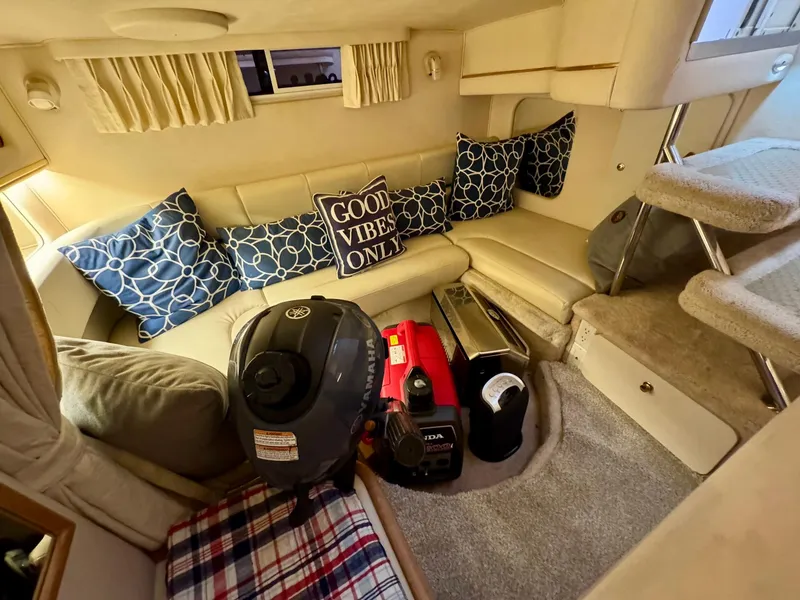 Slide: The Image of Interior of 2000 Sea Ray 310 Sundancer with cozy seating and nautical decor. - 32