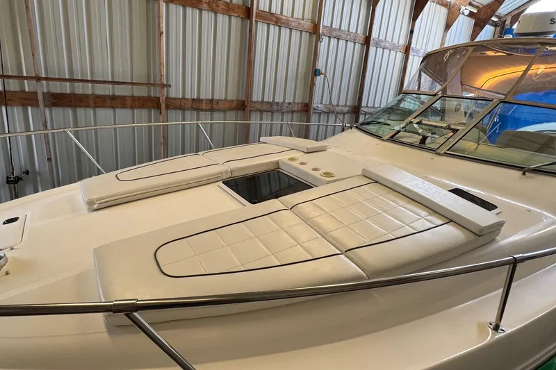 Slide: The Image of 2000 Sea Ray 310 Sundancer yacht with cushioned deck, stored indoors. - 40