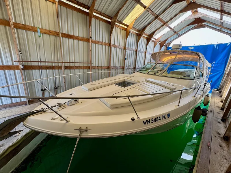 Slide: The Image of 2000 Sea Ray 310 Sundancer docked in a covered marina. - 41