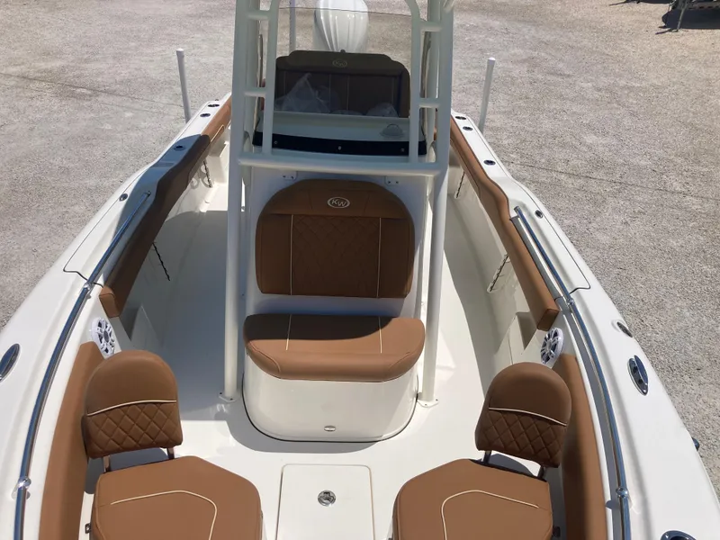 Slide: The Image of 2025 Key West 239FS boat interior with brown seating and white deck. - 10