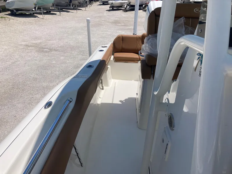 Slide: The Image of 2025 Key West 239FS boat interior with tan seating and sleek design. - 12